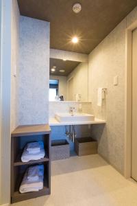 a bathroom with a sink and a large mirror at Sanco Inn Nagoya - Shinkansenguchi in Nagoya