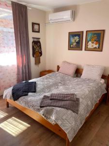 a bedroom with a bed with two towels on it at NiDo Cozy 3BR Apartment Kapana Top Center in Plovdiv