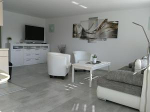 a living room with a couch and a table at Villa Vogelsang VO, Schwimmbad, Sauna in Sierksdorf