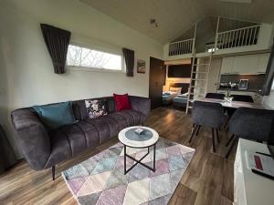 a living room with a couch and a table at Tiny House 1e in Varel