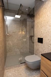 a bathroom with a toilet and a glass shower at Aurum Ponte Deluxe in Zadar
