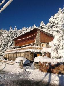 a building covered in snow with snow covered trees at Chambres d'hôtes Le Grand Chalet in Valdeblore