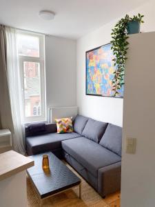 a living room with a couch and a table at New Cozy Apartments In Porte de HAL in Brussels