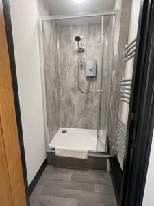 a bathroom with a shower with a glass door at Canalside Rooms in Taunton