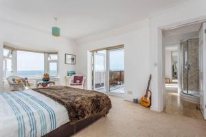 a bedroom with a bed and a guitar in it at Cooden Beach Corner - awesome views! in Bexhill