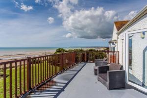 a balcony with a view of the beach at Cooden Beach Corner - awesome views! in Bexhill