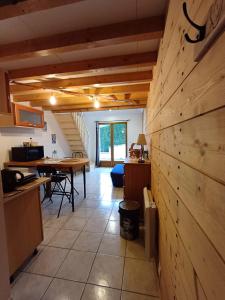 a kitchen and dining room with a wooden wall at guesthome la petite salette in Monestier-de-Clermont