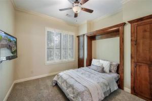 a bedroom with a bed and a ceiling fan at Grapevine Luxury Home in Grapevine