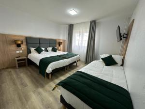 Postel nebo postele na pokoji v ubytování Hôtel NOROTEL