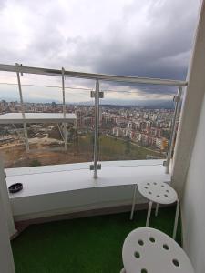 a window with a view of a city at 19th Floor Secure Condo with Pool, Fitness, Parking Included in Price in Skopje