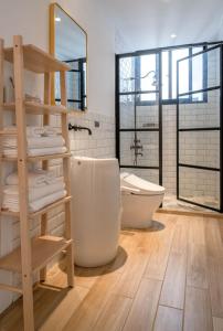 a bathroom with a white toilet and a sink at 鄢室民宿 in Hualien City +27 photos