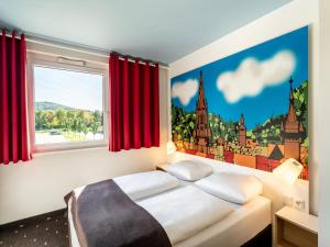 um quarto com uma cama com cortinas vermelhas em B&B Hotel Freiburg-Süd em Friburgo em Brisgóvia