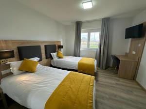 Postel nebo postele na pokoji v ubytování Hôtel NOROTEL