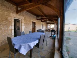 a dining room with a blue table and chairs at Maison du Pont de la Roussie in CazoulÃ¨s