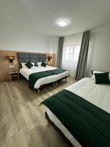 Postel nebo postele na pokoji v ubytování Hôtel NOROTEL