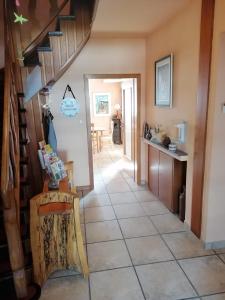 a hallway of a house with a staircase and a kitchen at Gästehaus Burg Molbach in Kreuzau