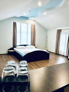ein Zimmer mit einem Bett und einem Tisch mit Gläsern darauf in der Unterkunft Meatsa Hotel in Kardschali + 123 Fotos
