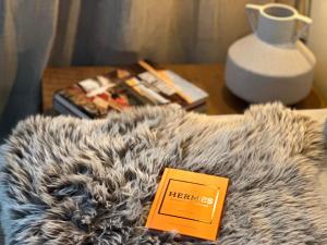 a table with a book and books on top of a fur couch at Ski Suites - A Luxury Maisonette Kalavryta in Kalavrita