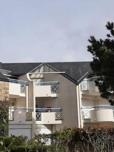 a large apartment building with balconies on the side of it at Nouveau * Ty Lévenez *pour 2 vacanciers * Parking in Carnac +15 photos