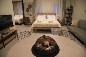 a living room with a bed and a tv at Cruzeto in Syvota