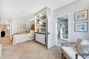 a white bedroom with a bed and a couch at Arcore Premium Apartments Regent Park in London
