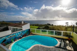 a swimming pool with a view of the ocean at Whale Song in Feteiras