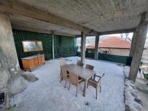a wooden table and chairs on a patio at Rose House in Kavála