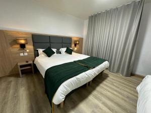 Postel nebo postele na pokoji v ubytování Hôtel NOROTEL