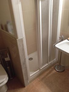 a bathroom with a shower and a toilet and a sink at Bons Aires in Llivia