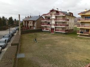 a person standing in a field in front of a building at Bons Aires in Llivia