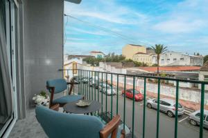 a balcony with chairs and a view of a street at Francisco Terrace in Ponta Delgada