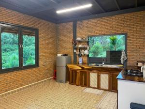 a kitchen with a sink and a window at Lam Nguyên Charming House in Bao Loc