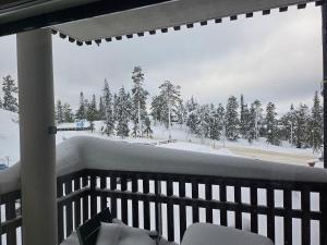 a balcony with a view of a snow covered mountain at Ruka Chalets Ski-In 1313 in Ruka