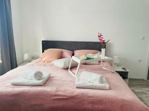 a bed with two towels and a table on it at Apartment Zara Bihac in Bihać