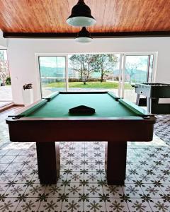 a pool table in a room with a ceiling at Penedo Village in Marco de Canaveses