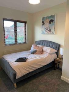 a bed in a bedroom with a large window at Close to Belfast City Centre.Modern Opened Planned in Belfast