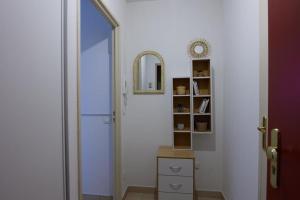 een hal met een deur en een spiegel en een dressoir bij À Laye station Charmant T1 33 m2 in Laye