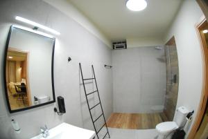 a bathroom with a shower and a sink and a mirror at Cruzeto in Syvota