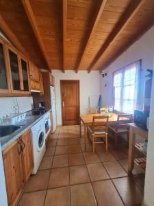 cocina con fregadero y mesa con lavadora en One bedroom bungalow with terrace at Carreteria 9 km away from the beach, en Moya