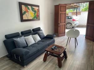 a living room with a blue couch and a table at Apartment near Waterfall of love, free Wifi in Jardin