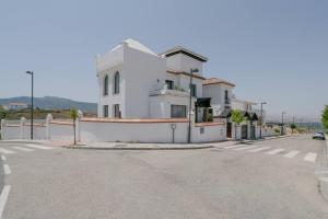 a white building on the side of a street at 7 bedrooms villa with private pool jacuzzi and wifi at Granada in La Zubia