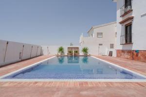 a swimming pool in the middle of a building at 7 bedrooms villa with private pool jacuzzi and wifi at Granada in La Zubia