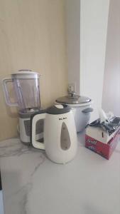 a kitchen counter with a blender and a toaster at aqilahomestay in Kampung Dengkil