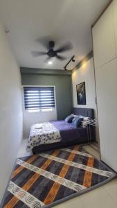 a bedroom with a bed and a ceiling fan at aqilahomestay in Kampung Dengkil