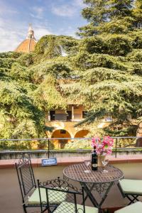 a table and chairs on a balcony with a tree at Penthouse Le Terrazze Duomo view in Florence