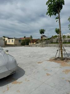 a car parked in a parking lot next to a tree at Home Sun Moon - Phòng Đôi in Phan Thiet