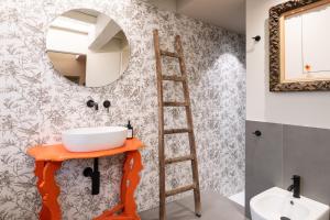 a bathroom with a sink and a mirror at Borgo35 in Parma