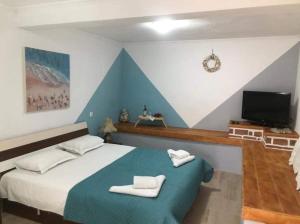 a bedroom with a bed with two towels on it at IslandTime Studio1 in Prinos