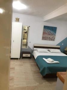a bedroom with a bed and a mirror in it at IslandTime Studio1 in Prinos +8 photos