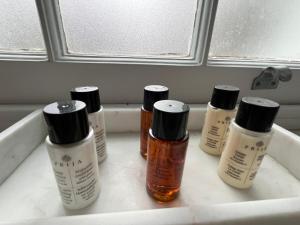 four bottles of essential oils sitting on a sink at The Georgian House in London